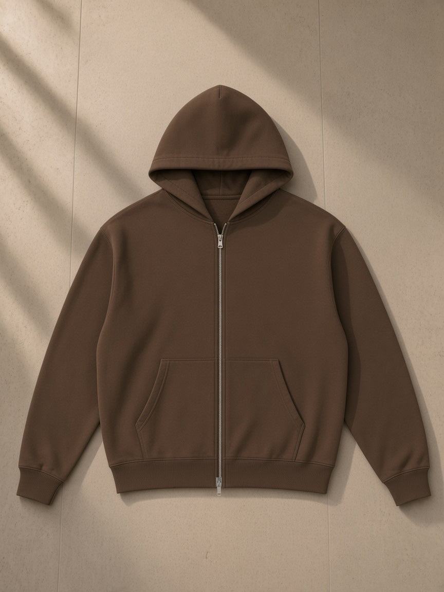 Unisex loose full zip hoodie in Coffee, laid flat on pale limestone, front view