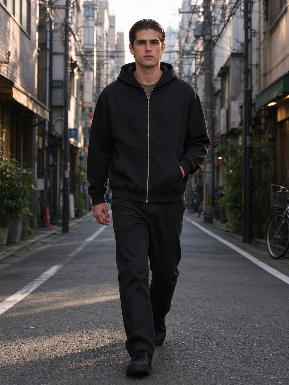 Man wearing the Men's Essential Heavyweight High Neck Zip-Up Hoodie in Black, full-length model photo