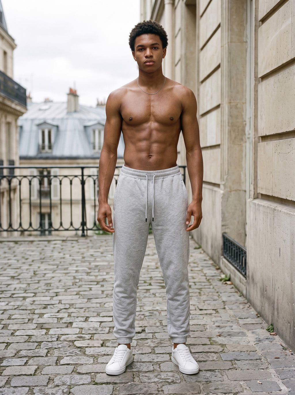 Man wearing the Marcel Afters Men's Heavyweight Fleece Joggers in Flower Gray, full-length editorial photograph