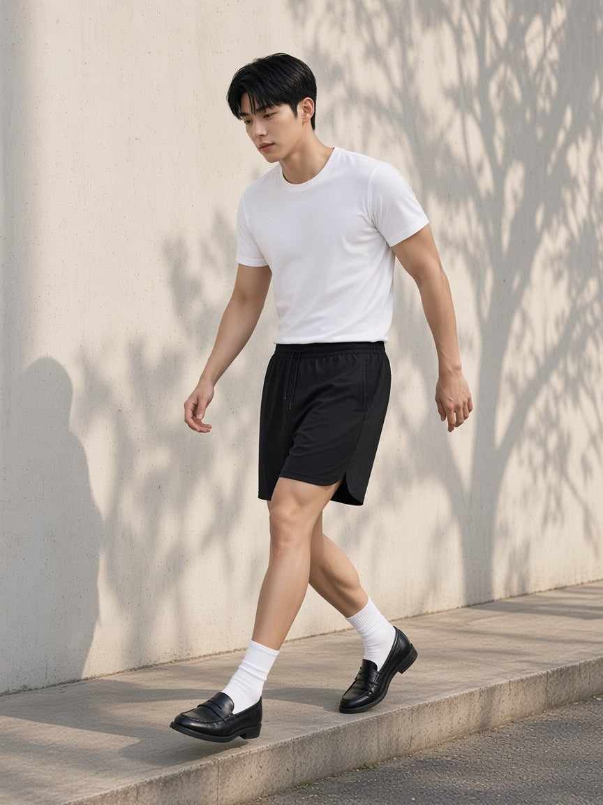 Marcel Afters Mesh-Lined Quick-Dry Performance Shorts in Black, worn by a man, outdoors