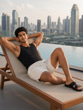 Marcel Afters Mesh-Lined Quick-Dry Performance Shorts in Grayish White, worn by a man, reclining on a rooftop pool lounger above a skyline