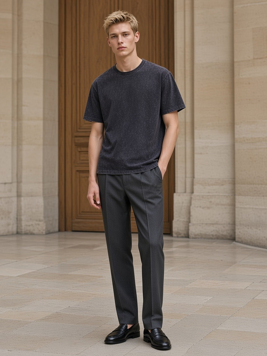 Marcel Afters Mineral Wash Boxy Cotton T-Shirt in Dark Gray, worn by a man, stone floor