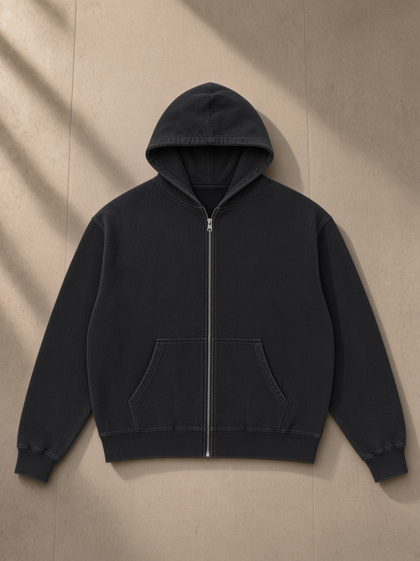 Mineral Wash Boxy Full Zip Hoodie in Black, laid flat on pale limestone, front view