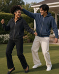 Two people in Black and Navy Blue mineral wash boxy full zip hoodies on a club lawn