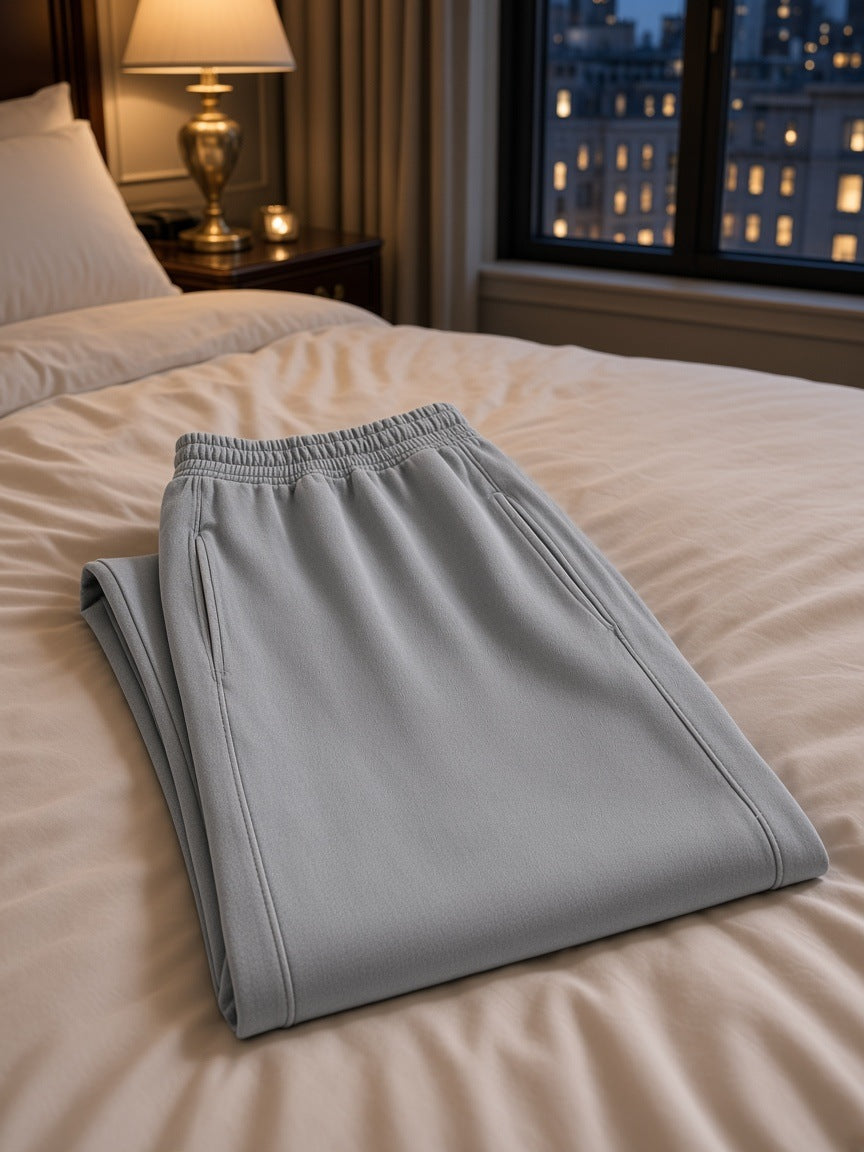 Marcel Afters Mineral Wash Straight Sweatpants in Light Gray, laid flat, bedroom