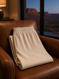 Marcel Afters Mineral Wash Straight Sweatpants in Apricot, laid flat, living room