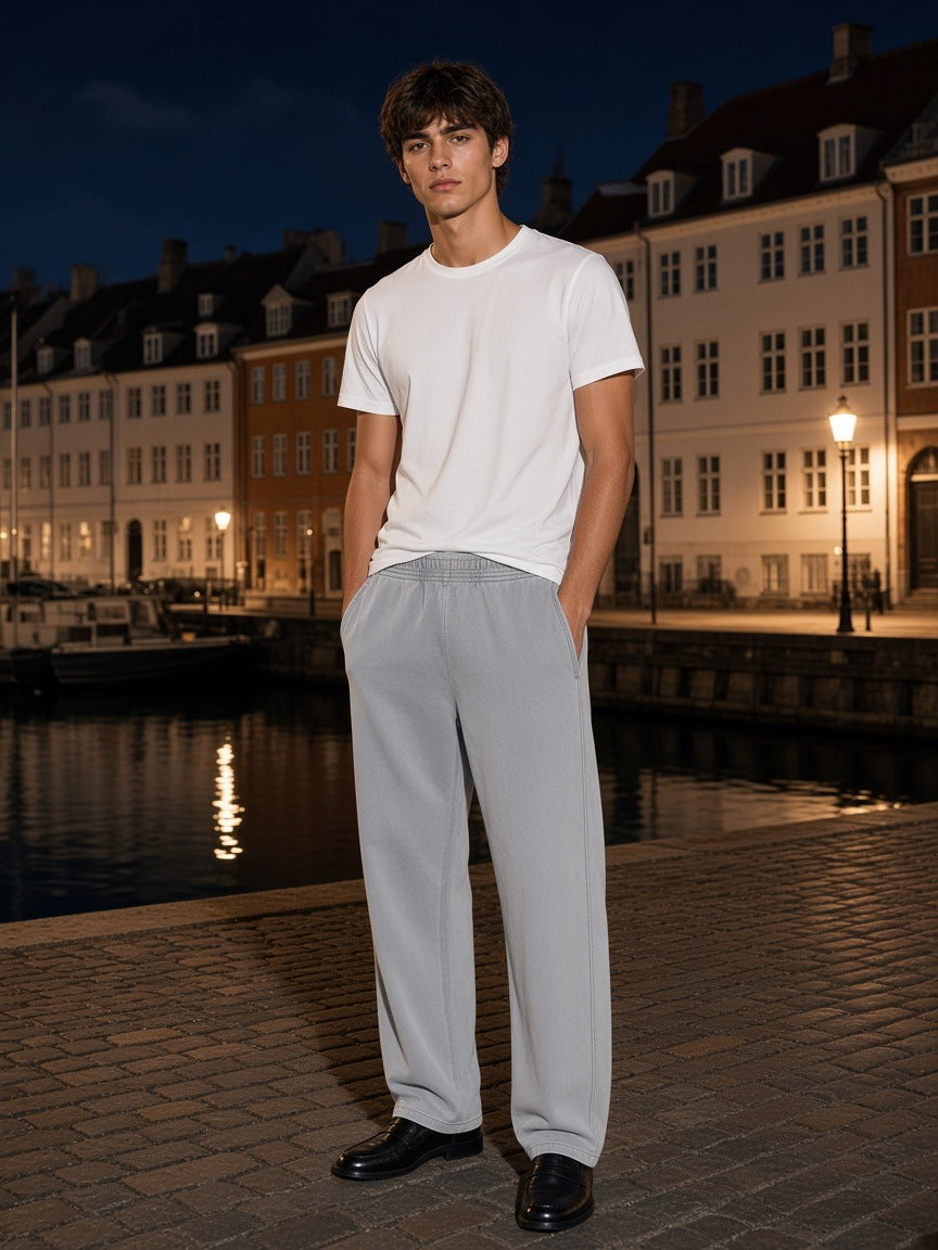 Marcel Afters Mineral Wash Straight Sweatpants in Light Gray, worn by a man, city street
