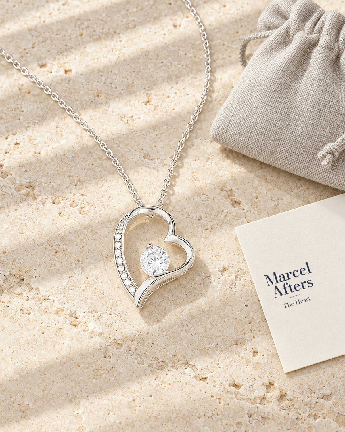 Crystal Heart Pendant Necklace — flat lay with Marcel Afters gift card and pouch