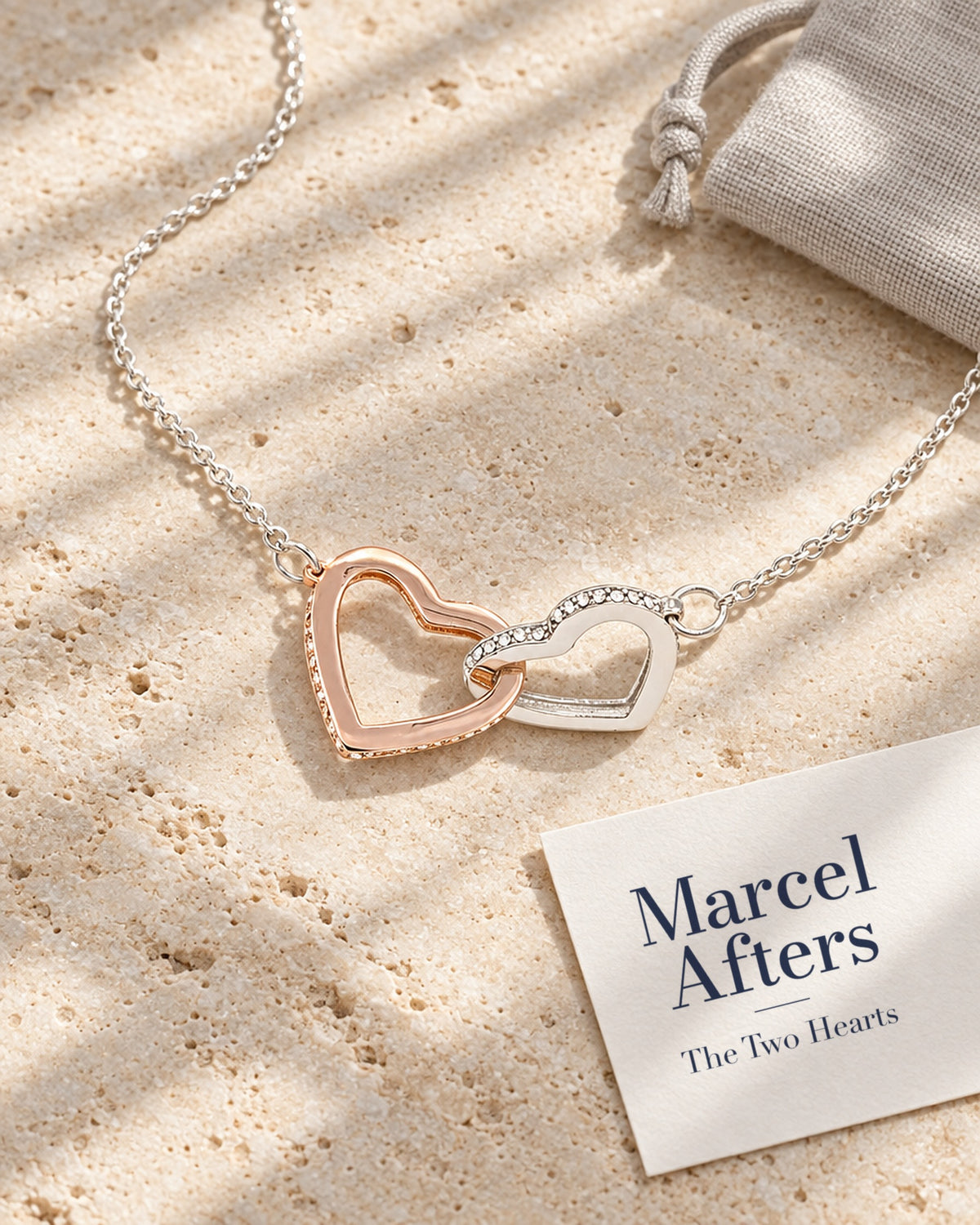 Interlocking Hearts Pendant Necklace — flat lay with Marcel Afters gift card and pouch