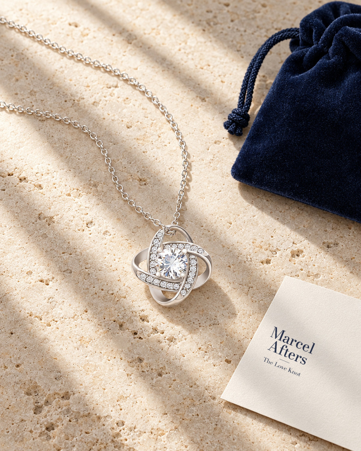 Love Knot Pendant Necklace — flat lay with Marcel Afters gift card and pouch