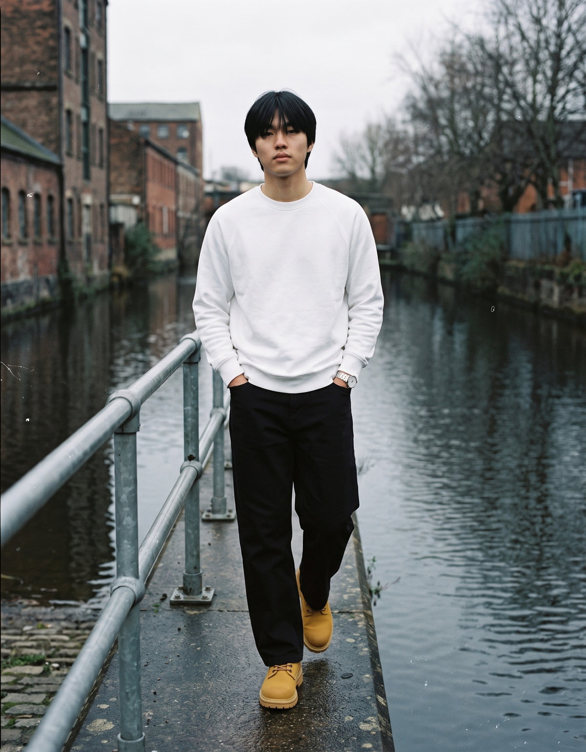 Man wearing The Yellow Cab Derby with the Regular Fit Crewneck Sweatshirt in White, Heavyweight Straight-Leg Trousers in Black. Weekend Uniform, Autumn–Winter 2026 campaign
