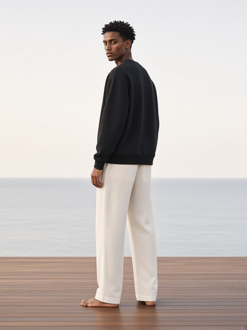 Man wearing the Oversized V-Neck Sweatshirt in Black, full-length model photo