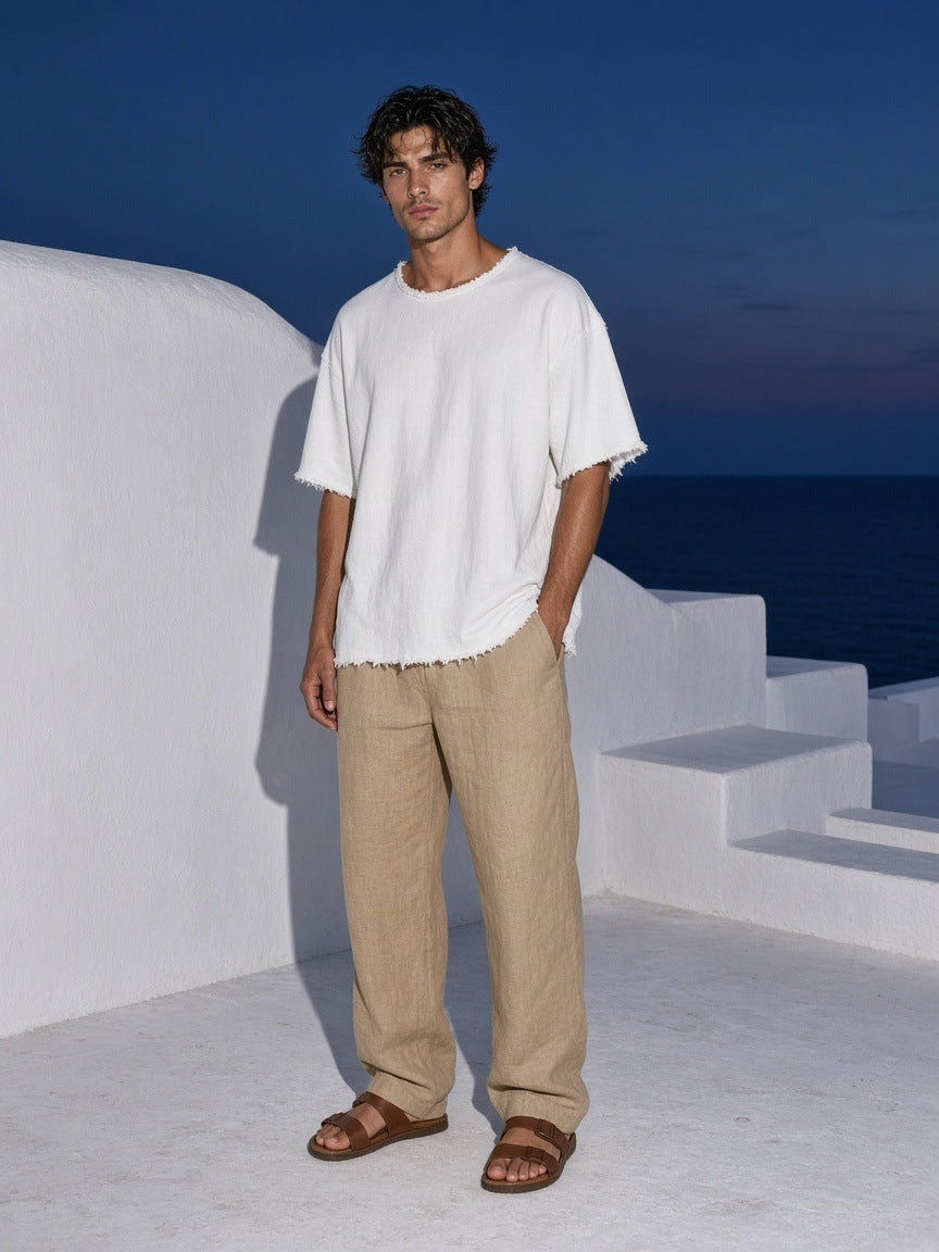 Marcel Afters Raw Edge Boxy Non-Shrink T-Shirt in White, worn by a man, white rooftop