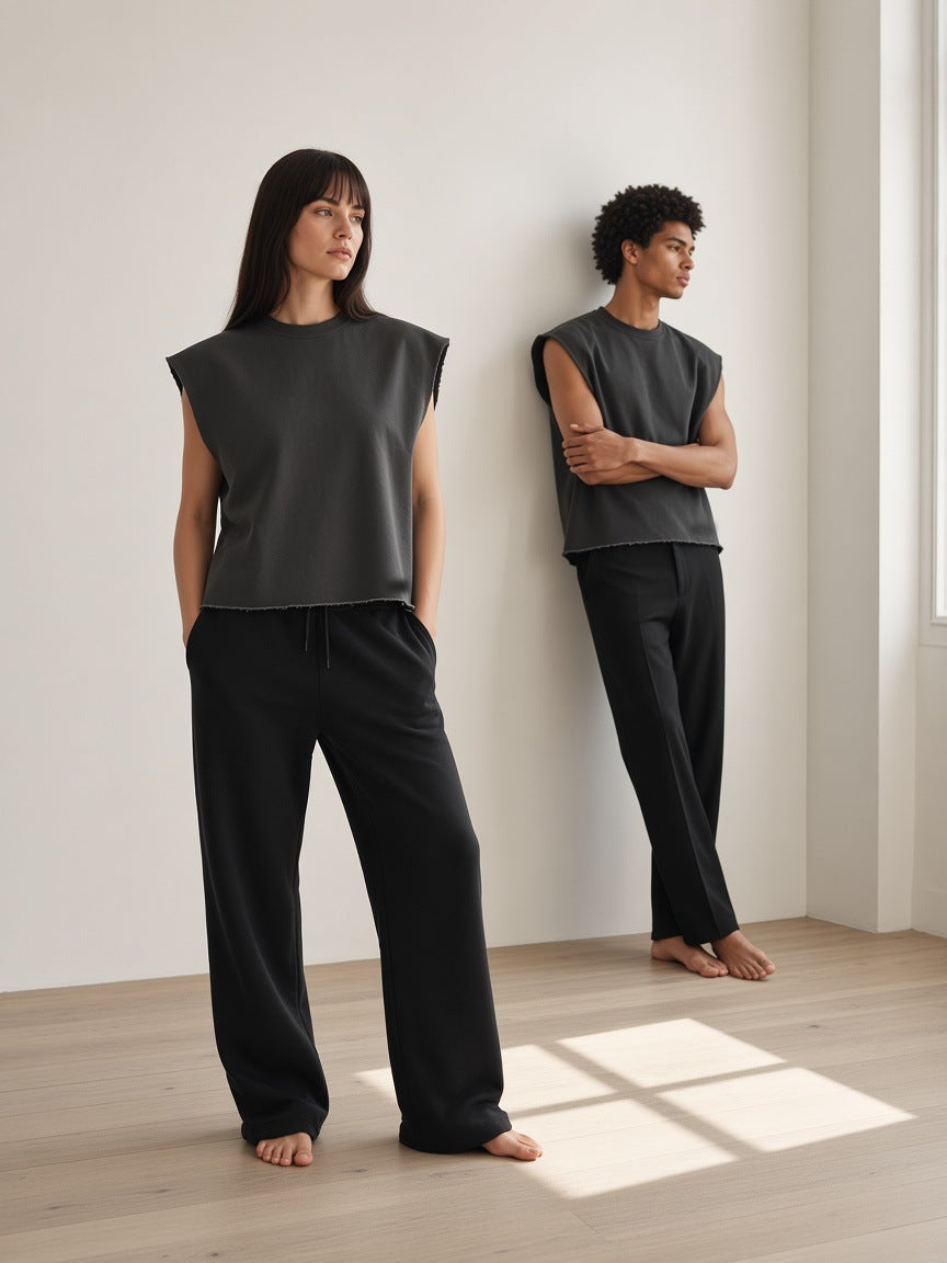 Marcel Afters Raw Edge Boxy Non-Shrink T-Shirt in Dark Gray, worn by a man and a woman, standing in a white room in dark boxy tees and black trousers