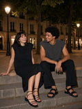 Two people in the Raw Edge Boxy Non-Shrink T-Shirt in Black and Dark Gray on the steps of Place Dauphine in Paris at night
