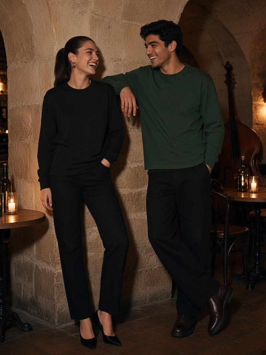 Marcel Afters Raw Hem Long Sleeve T-Shirt in Black, worn by a woman, stone wall