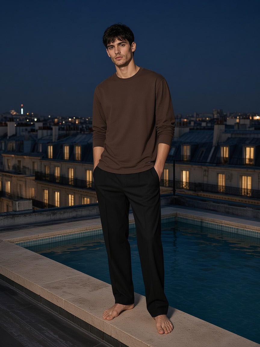 Marcel Afters Raw Hem Long Sleeve T-Shirt in Coffee, worn by a man, rooftop