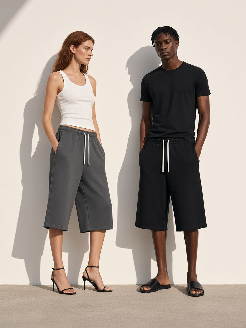 Marcel Afters Relaxed Drawstring Three-quarter Sweatpants in Charcoal Gray, worn by a woman, against a plain white background