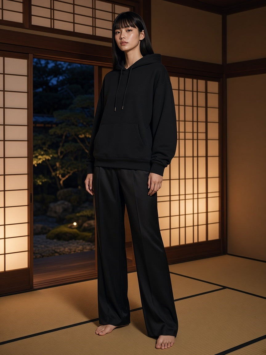 Marcel Afters Relaxed Pullover Hoodie in Black, worn by a woman, japanese room