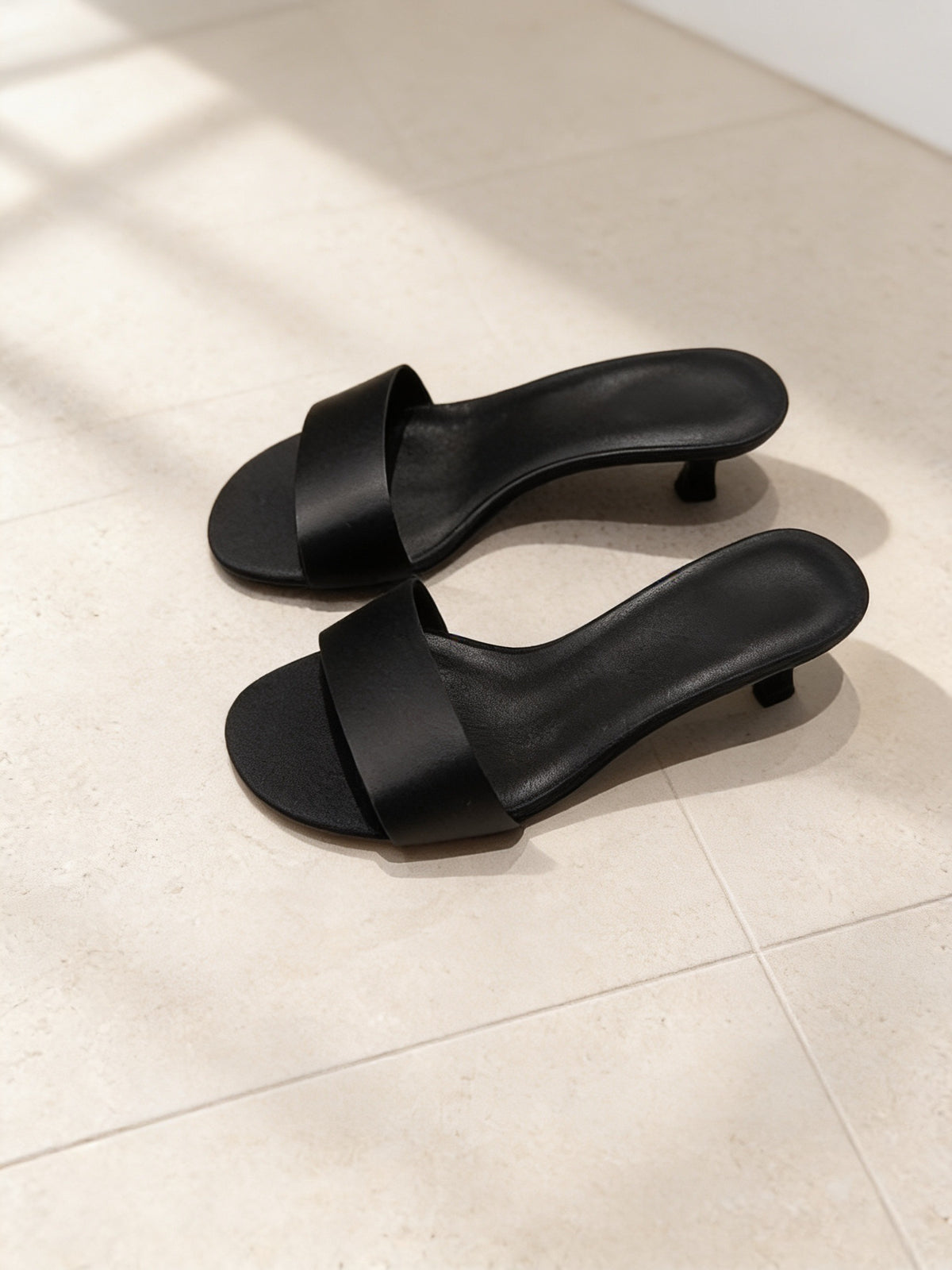 The Room Service Slide in Black, pair on pale limestone