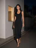 Woman in the Slim Sleeveless Dress in Black walking a gallery street in Hannam-dong, Seoul at night
