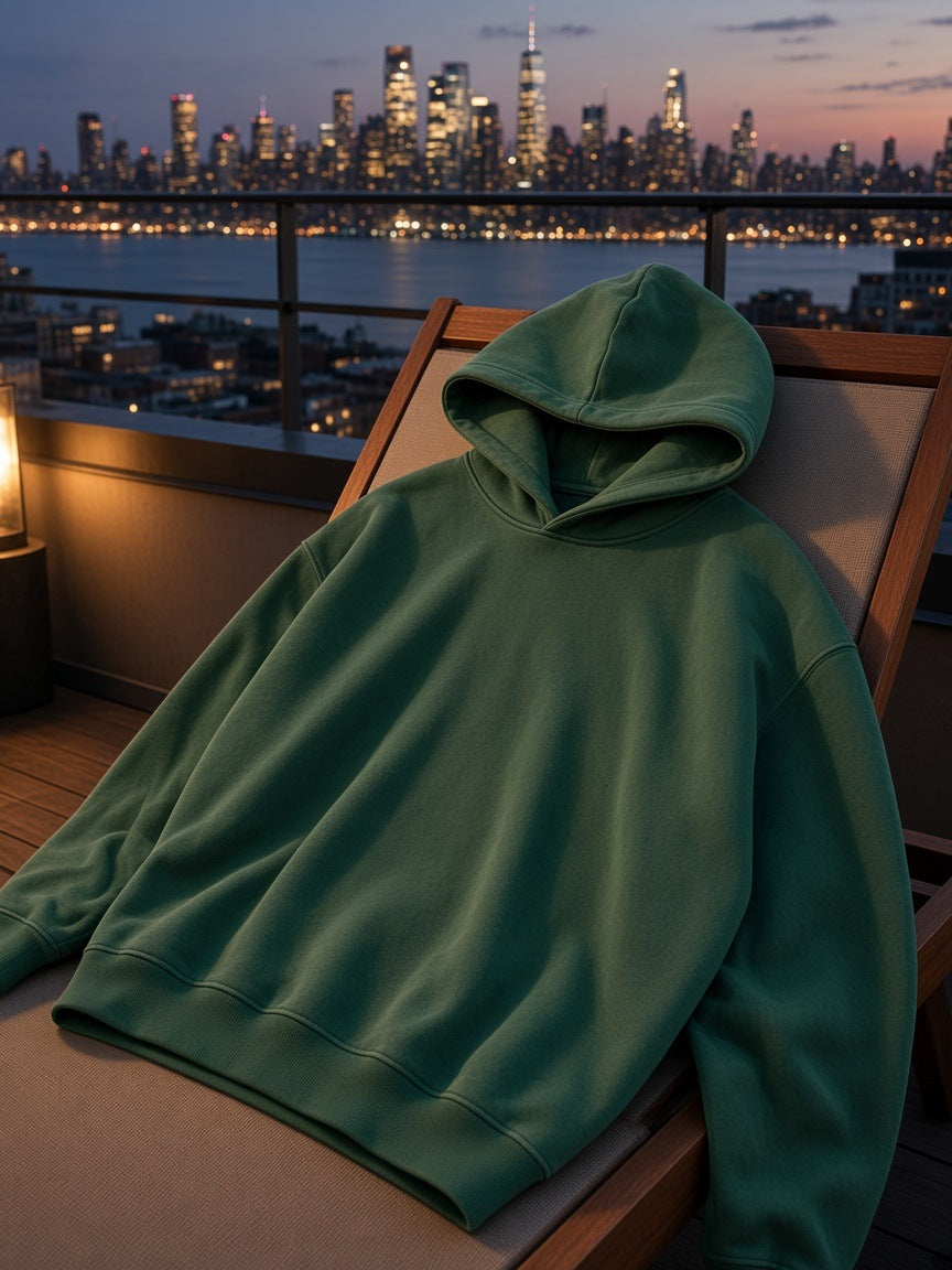 Marcel Afters Snow Wash Fleece Oversize Hoodie in Green, laid flat, city rooftop at dusk