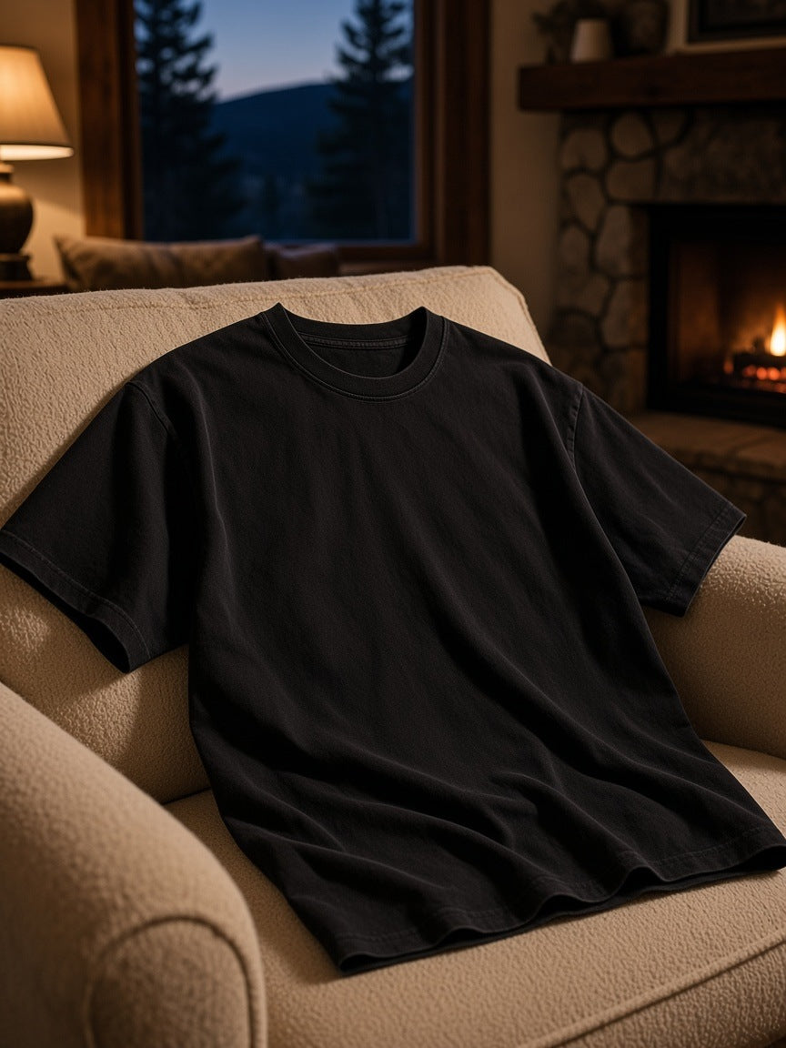 Marcel Afters Snow Washed Heavyweight Oversize T-Shirt in Black, laid flat, living room