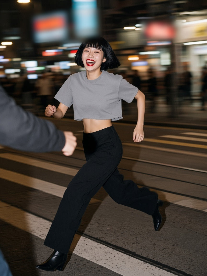 Woman in the Snow Washed Raw Edge Crop Top in Gray, running across a Hong Kong crossing at 1am