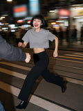 Woman in the Snow Washed Raw Edge Crop Top in Gray, running across a Hong Kong crossing at 1am