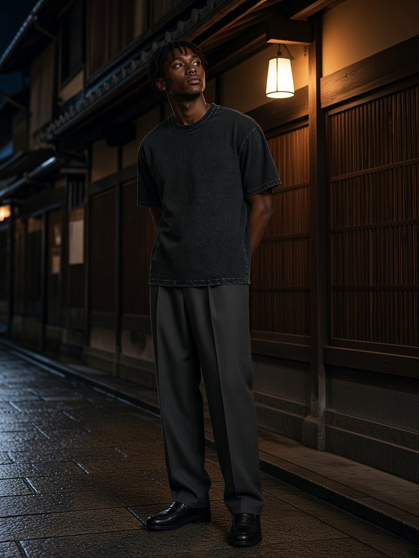 Marcel Afters Snow Washed Raw-Edge Neckline T-Shirt in Black, worn by a man, standing under a lantern on a Kyoto side street at night