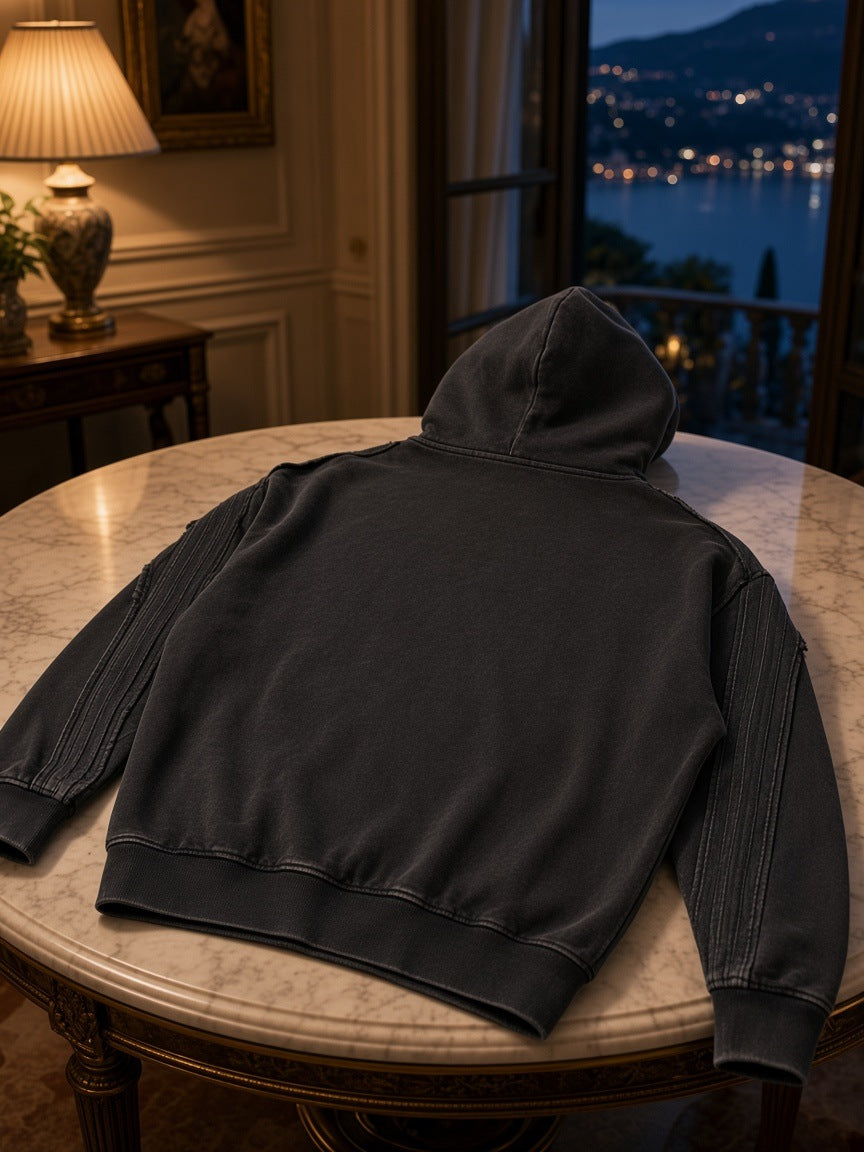 Marcel Afters Snow Washed Tape Raw Edge Zip Hoodie in Black, laid flat, dark room