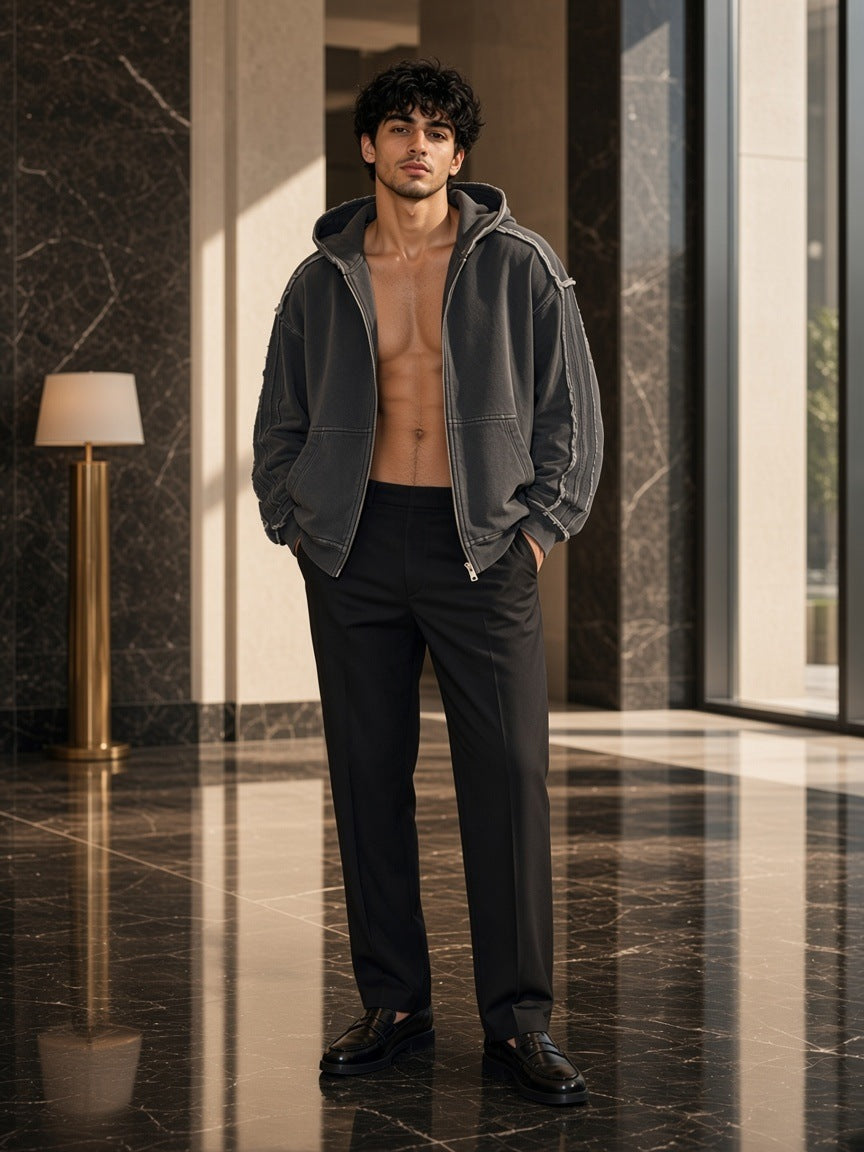 Marcel Afters Snow Washed Tape Raw Edge Zip Hoodie in Black, worn by a man, modern marble interior