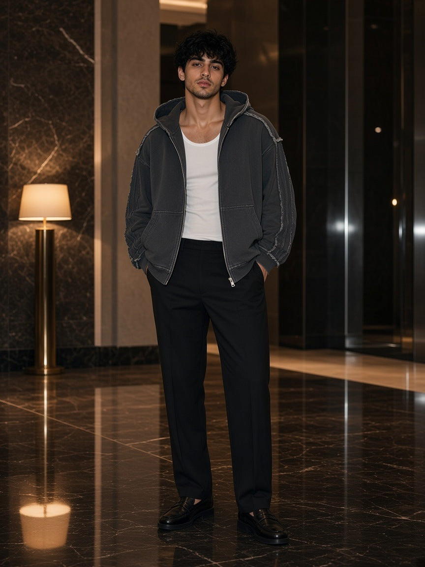 Marcel Afters Snow Washed Tape Raw Edge Zip Hoodie in Black, worn by a man, dark marble floor