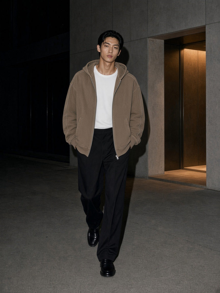 Man in the Snow Washed Tape Raw Edge Zip Hoodie in Khaki worn open walking through Aoyama, Tokyo at night