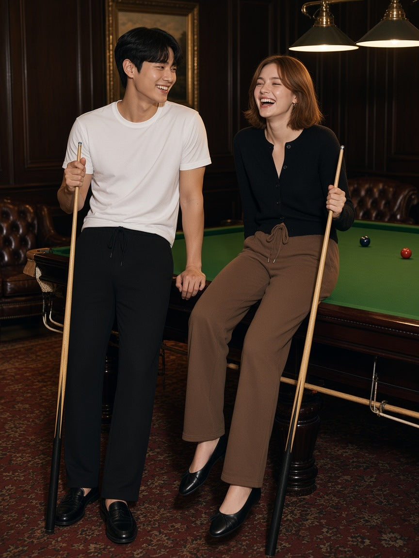 Two people in the Solid Color Straight-Leg Sweatpants in Black and Coffee in a members' club snooker room at night