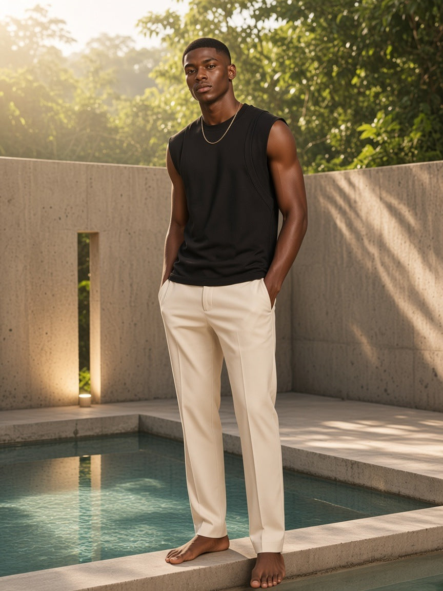 Marcel Afters Spliced Panel Sleeveless Muscle T-Shirt in Black, worn by a man, outdoors