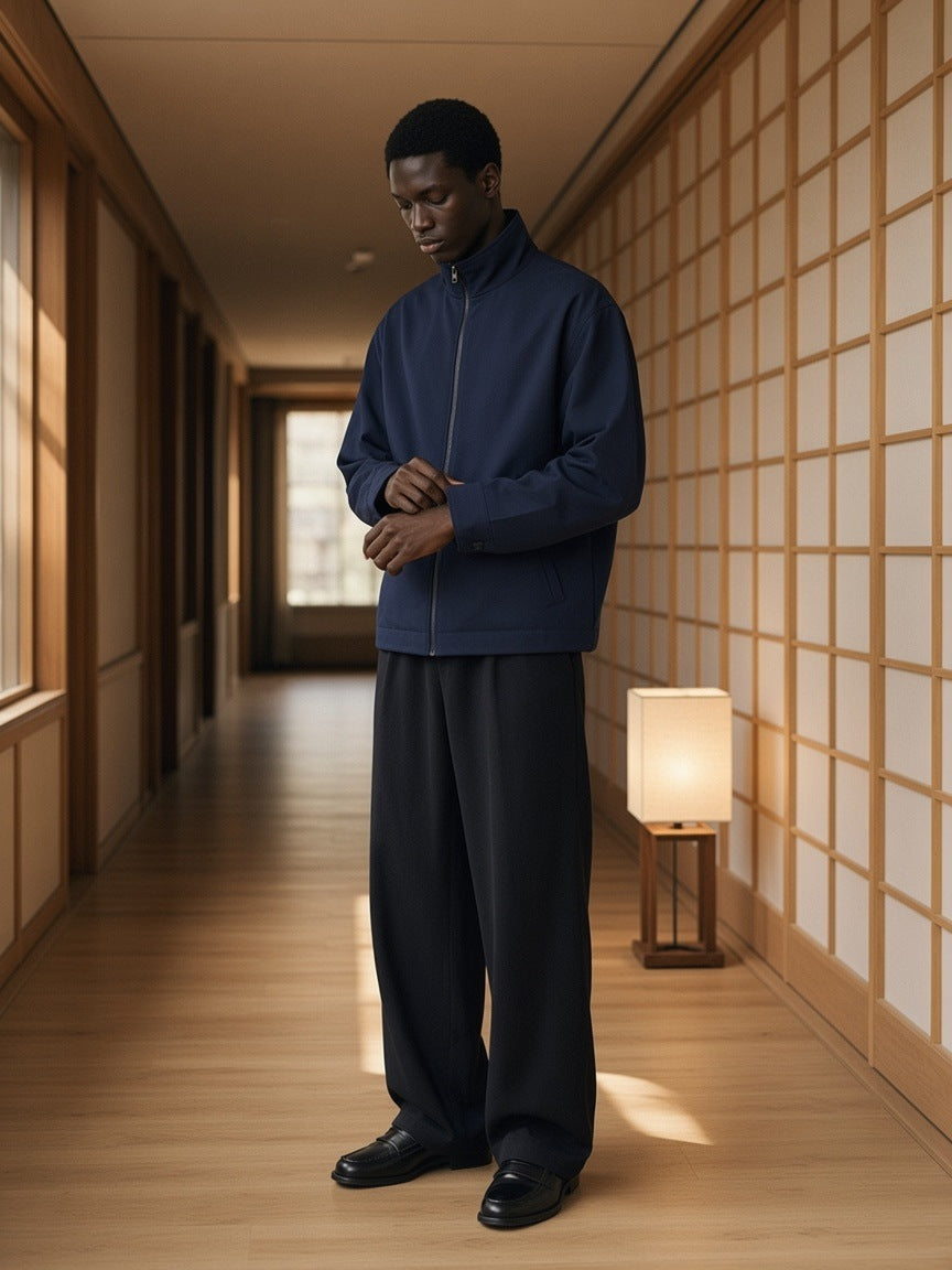 Marcel Afters Stand Collar Jacket in Navy Blue, worn by a man, standing in a wood-and-paper-screen corridor