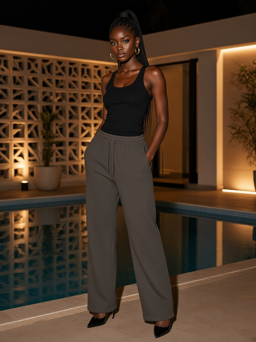Marcel Afters Straight Leg Sweatpants in Blackish Green, worn by a woman, poolside