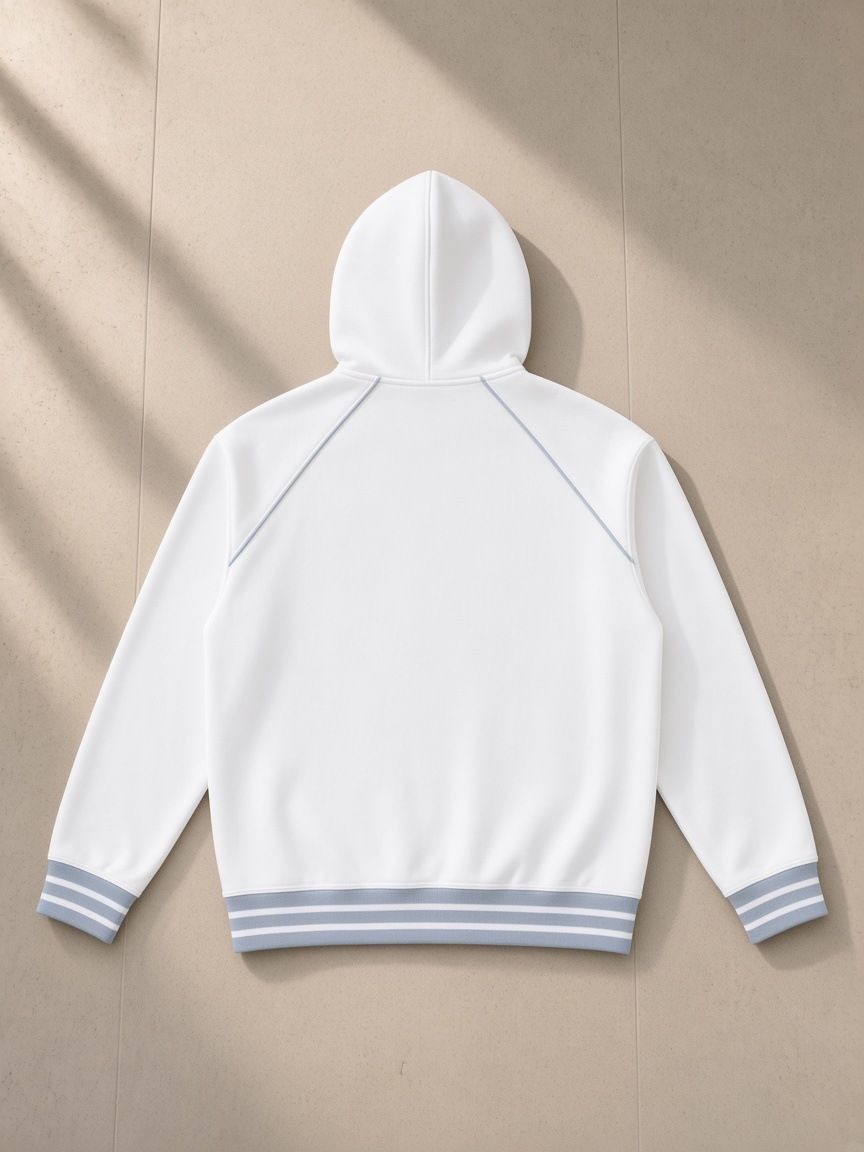 Striped-trim zip-up hoodie in White, laid flat on pale limestone, back view