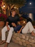 Marcel Afters Sun Fade Raw Edge T-Shirt in Black, worn by a man, by the sea