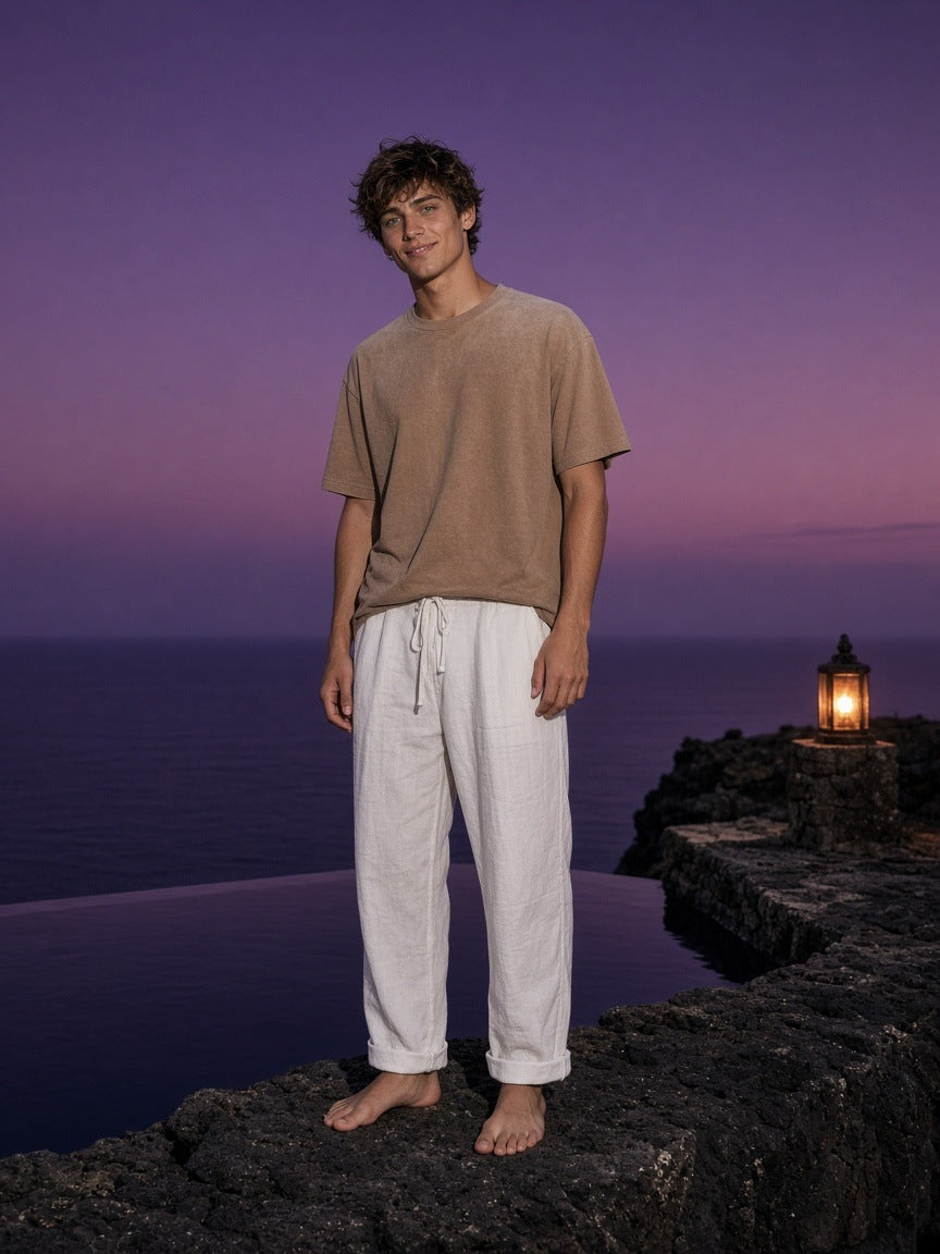 Marcel Afters Sunfade T-Shirt in Tan, worn by a man, ocean at sunset