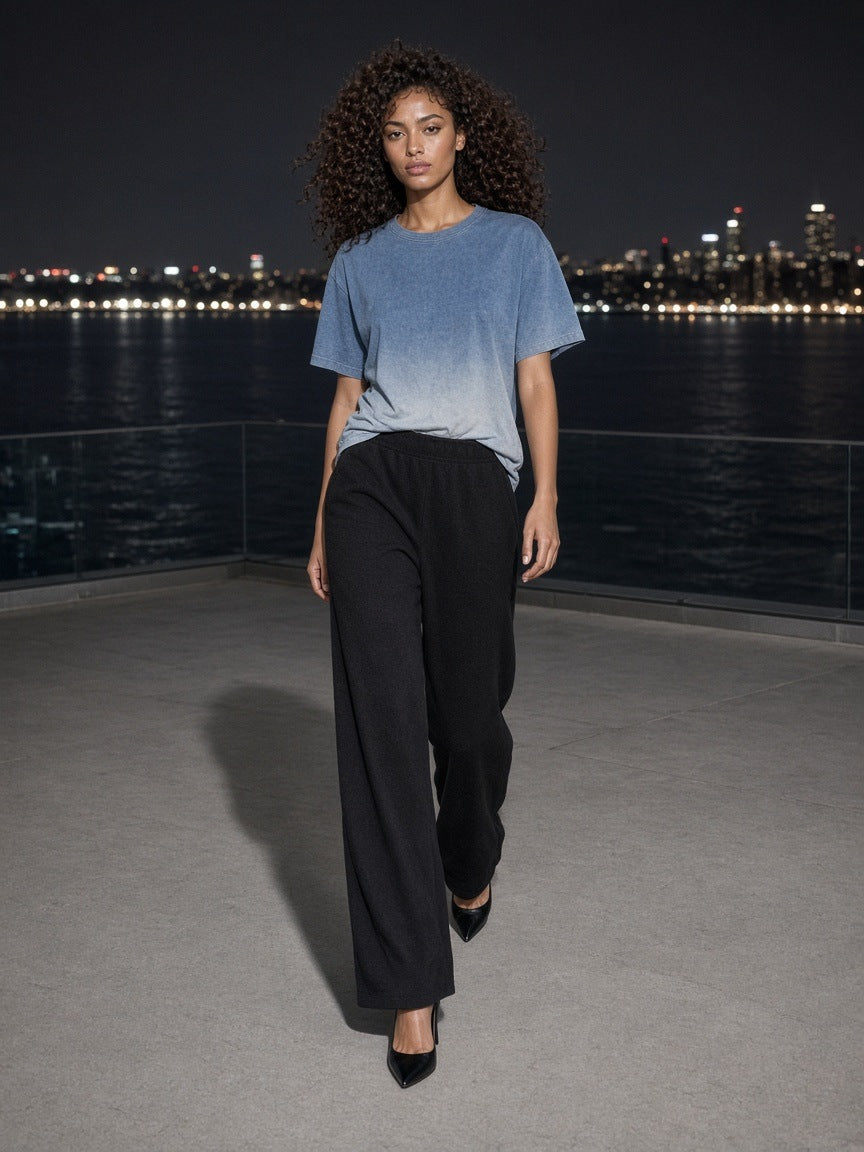 Marcel Afters Sunfade Vintage Washed T-Shirt in Blue, worn by a woman, city skyline