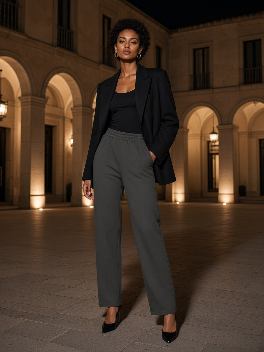 Marcel Afters Tapered Straight Hem Sweatpants in Dark Gray, worn by a woman, courtyard