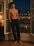 Marcel Afters Tapered Straight Hem Sweatpants in Black, worn by a man, paris apartment
