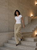 Woman in the Women's Tencel Baby T-Shirt in White on a travertine palazzo stair in Milan a