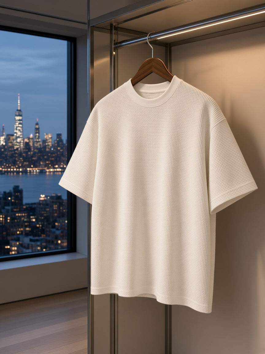 Marcel Afters Textured Waffle Washed Boxy T-Shirt in White, on a hanger, city