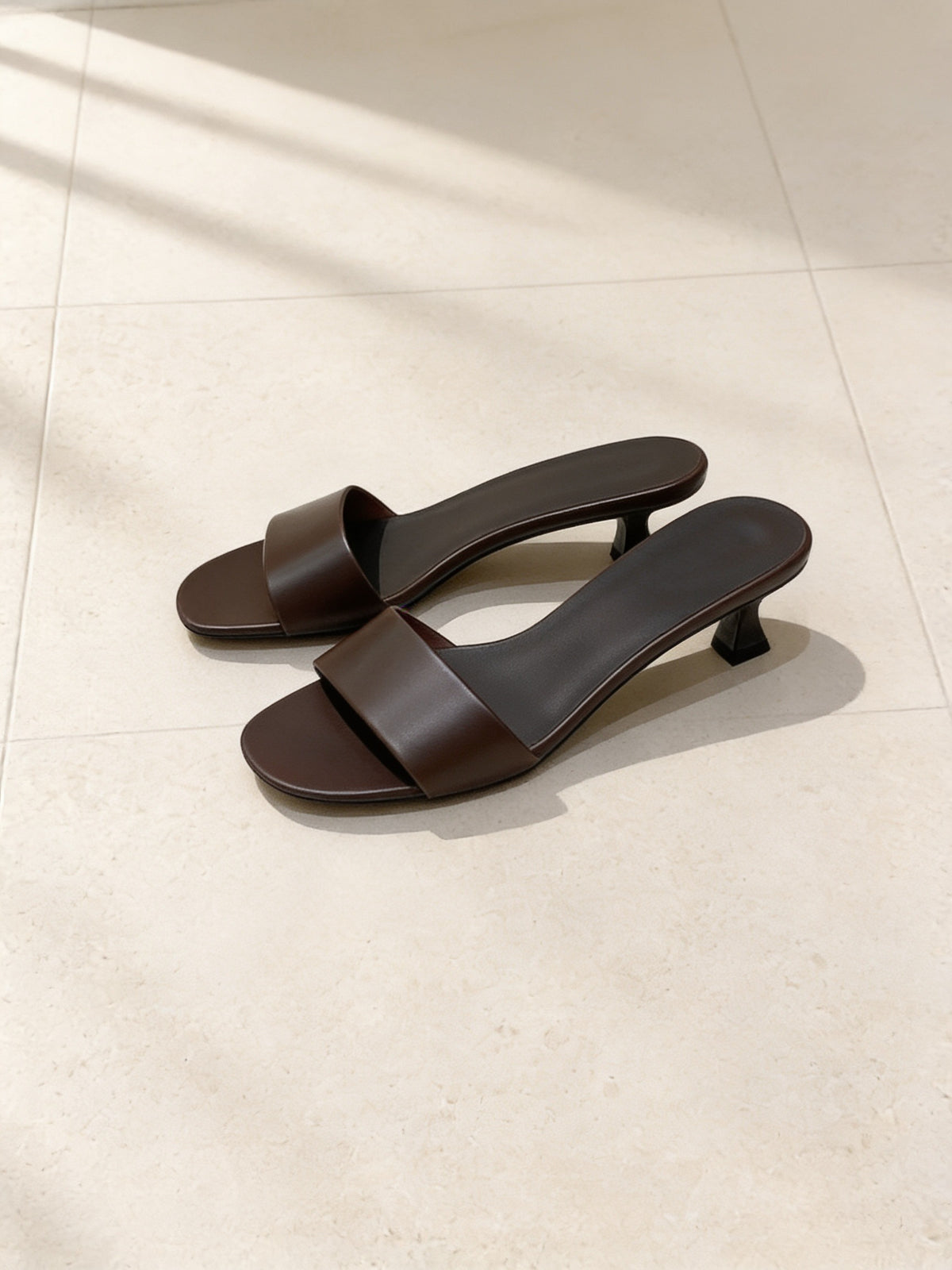 The Espresso Martini Mule in Dark Brown, pair on pale limestone