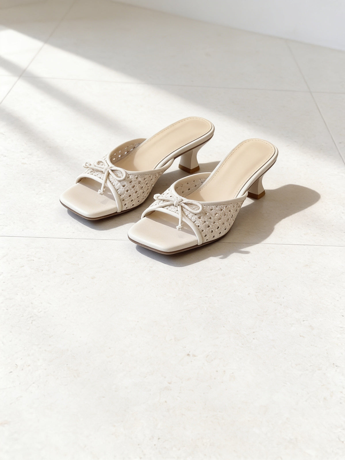 The Garden Party Mule in Beige, pair on pale limestone