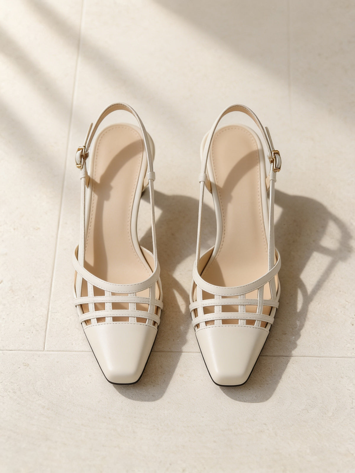 The Gilded Cage Slingback in Beige, pair on pale limestone