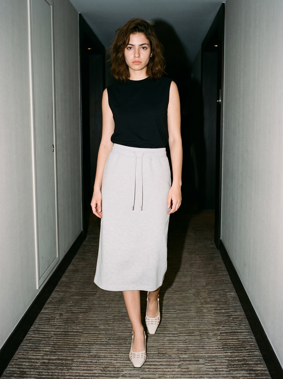 Woman wearing The Gilded Cage Slingback in Beige with flower gray midi drawstring-waist jersey skirt and a black tank top, flash photograph